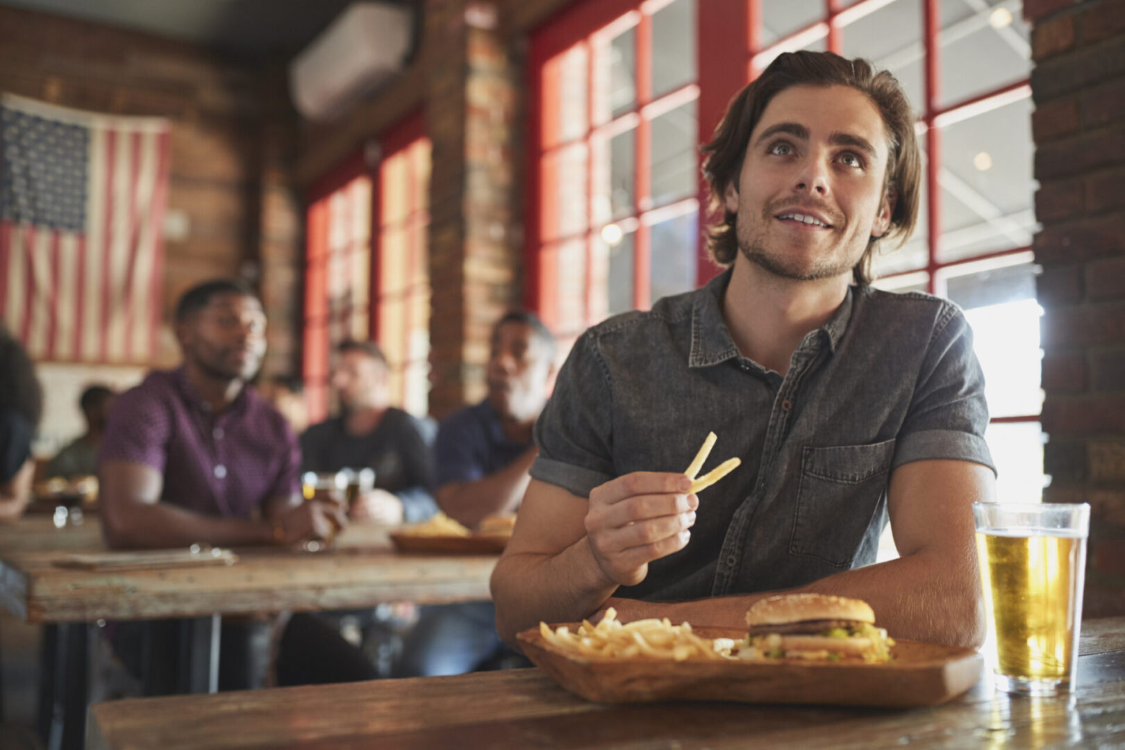 Smiling man enjoying lunch with friends