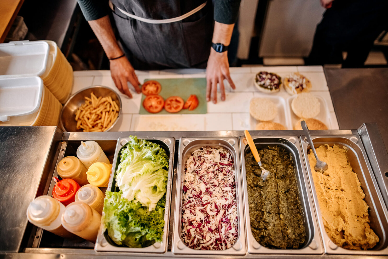 Chef preparing sandwich ingredients