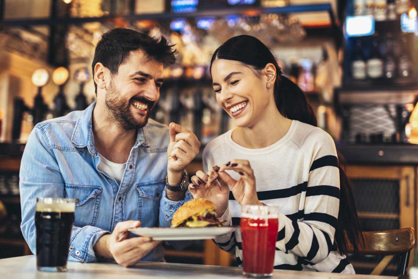 Smiling friends sharing a meal together